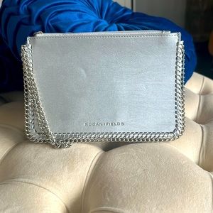 Rodan + Fields stylish silver with chain clutch